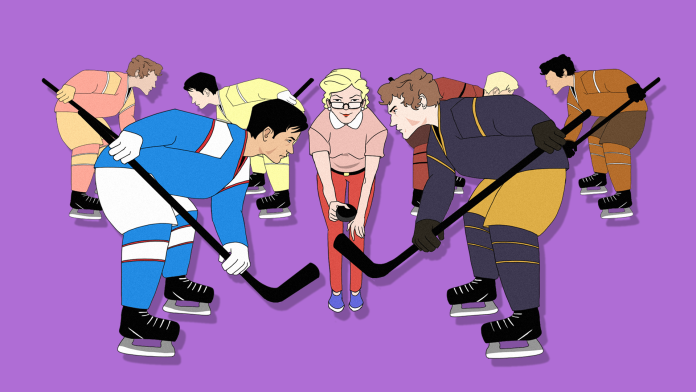 A white woman dropping the puck between two hockey players. Behind them are other hockey players in a similar position.